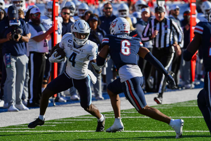 Old Dominion Monarchs wide receiver Javon Harvey (4) runs after a catch while being pursued by Liberty Flames defensive back Brandon Bishop (6) during the second half at Williams Stadium.